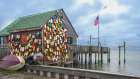 USA, New Jersey. Fishing floats and sun disc as wall decorations. Art Print